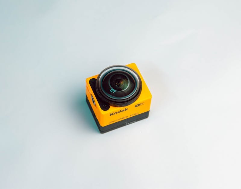Kodak action camera with a yellow body and lens, featured in a review of high-tech gadgets for photography enthusiasts.