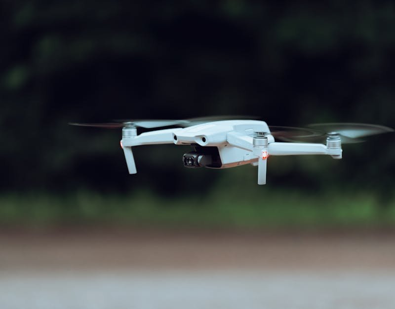 Drone equipped with a camera flying outdoors, showcasing advanced aerial technology relevant to high-tech drone reviews and buying guides.