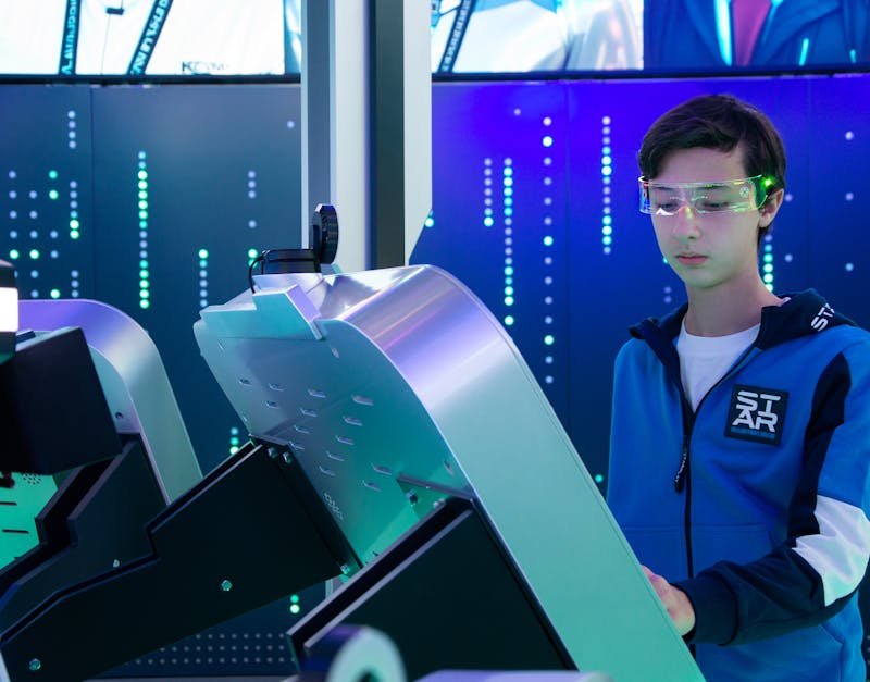 Teen engaging with modern interactive technology setup wearing smart glasses.