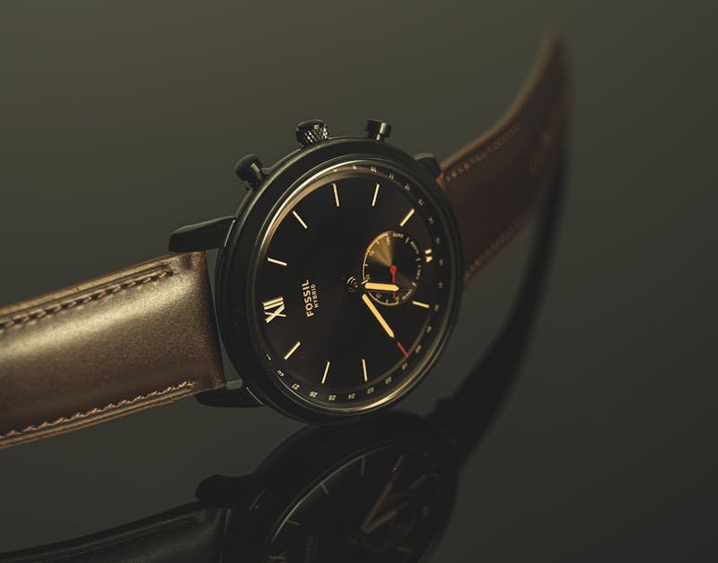 Luxurious black wristwatch with leather strap and analog display in close-up view.
