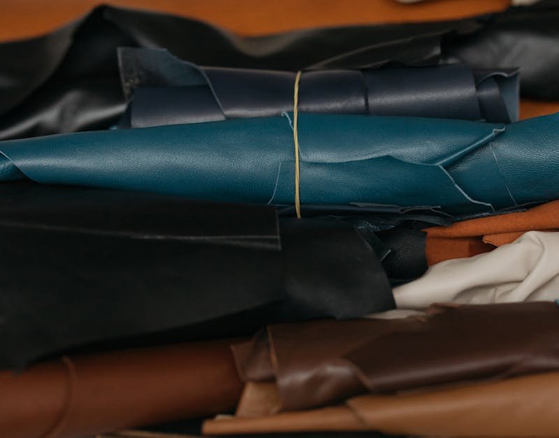 Close-up view of colorful leather rolls, perfect for crafting and textile production.