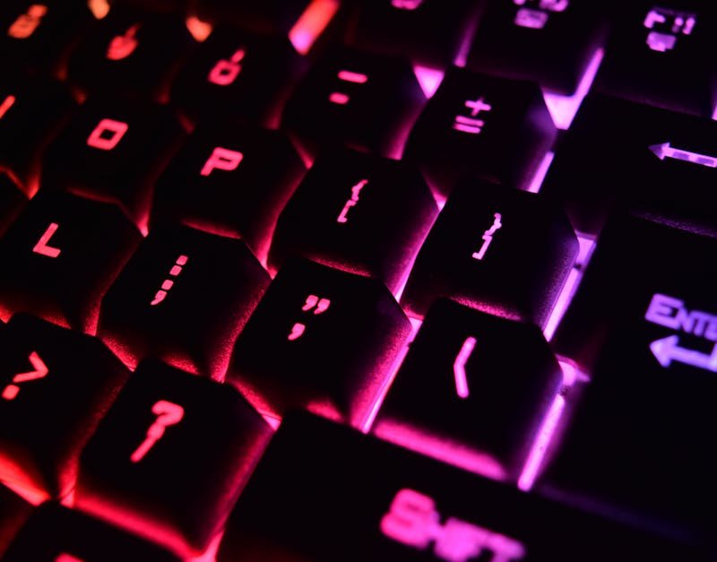 Vibrant close-up of a modern RGB backlit mechanical keyboard with glowing keys.