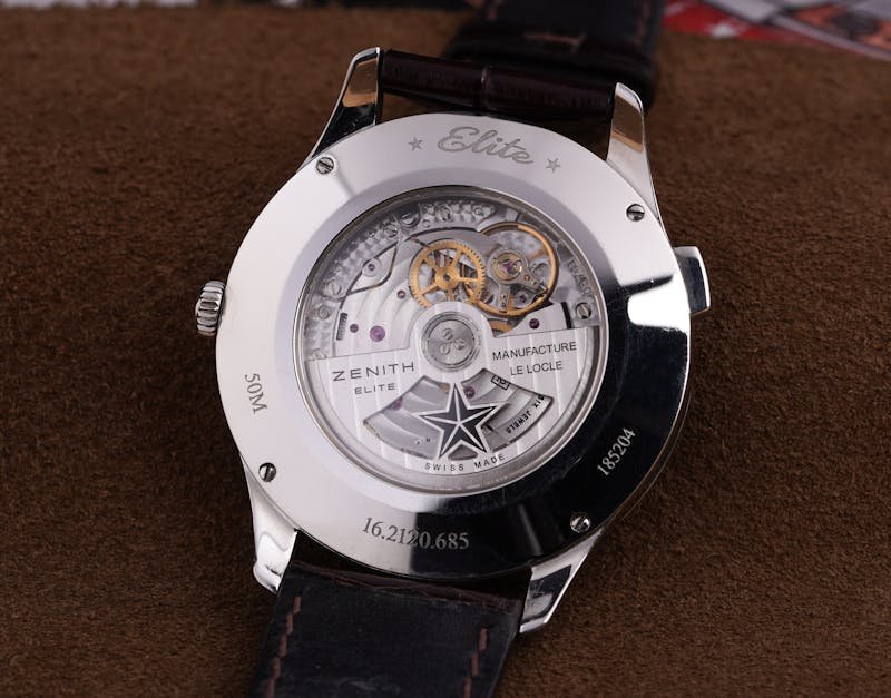 Close-up of a luxury Zenith Elite watch showcasing intricate mechanics and elegant design.